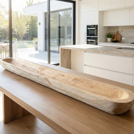 Hand-carved paulownia wood dough bowl filled with preserved moss on a dining table