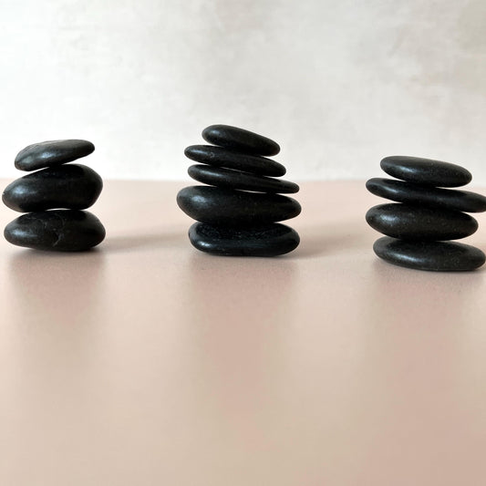 Smooth polished black river stones for stacking